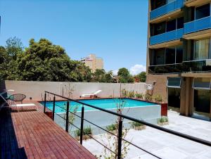 a swimming pool on the side of a building at DFC by FMA Coliving in Salta