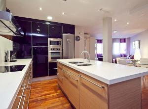 a kitchen with a white counter top and wooden floors at Ciutadella Park Born in Barcelona
