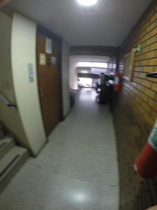a hallway in an office building with a long corridor at Hotel Sao Nicolau in Taubaté