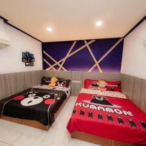 a bedroom with two beds with hello kitty beds at Liu Love B&B in Xiaoliuqiu