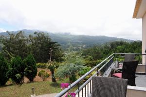 a balcony with a view of a mountain at Quinta Da Cova Do Milho in Santo da Serra