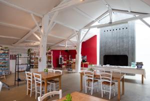 a room with tables and chairs in a library at Domaine de l'Oiselière in Chauché