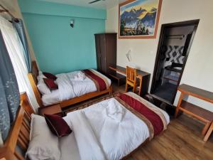 Postel nebo postele na pokoji v ubytování DnD Apartment Pokhara
