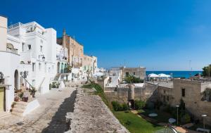 a view of a street with white buildings and the ocean at Palazzo Mulini in Monopoli