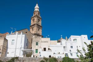a building with a clock tower on top of it at Palazzo Mulini in Monopoli