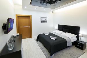 Postel nebo postele na pokoji v ubytování Prestige Apartamenty VINCI Centrum