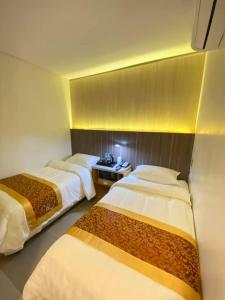 Katil atau katil-katil dalam bilik di Kojõ Hotel Tagum