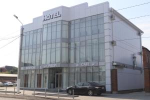 a black car parked in front of a building at Union Hotel Grozny in Groznyy