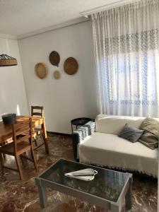 a living room with a couch and a table at Apartamentos Ermitana 22 in Peniscola