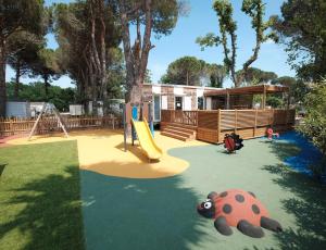 a playground with a slide and a teddy bear at Camping Taxo Les Pins - Maeva in Argelès-sur-Mer