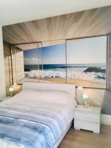 a bedroom with a bed with a view of the ocean at RESIDENZA ELENA in Rimini