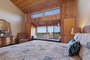 a bedroom with a large bed and a window at Windrow Retreat in Sea Ranch