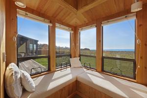 a room with windows and a bed in a house at Windrow Retreat in Sea Ranch