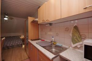 A kitchen or kitchenette at Fortuna Apartman