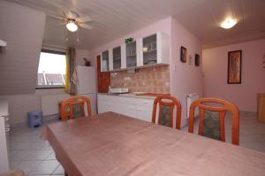 A kitchen or kitchenette at Fortuna Apartman