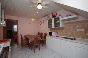 A kitchen or kitchenette at Fortuna Apartman