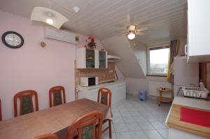 A kitchen or kitchenette at Fortuna Apartman