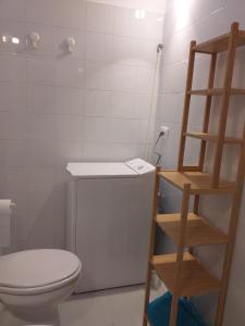 a bathroom with a toilet and a book shelf at Casale Torre San Magno in Corato +76 photos