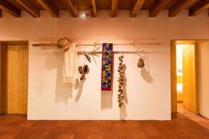 a room with a wall with hats and other items at Hotel Ayook in Oaxaca City