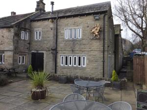 a building with a table and chairs in front of it at The Griffin Inn in Halifax