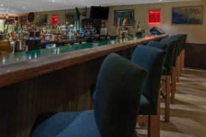 a bar with a row of chairs in front of a bar at Days Inn By Wyndham Carlisle North in Carlisle