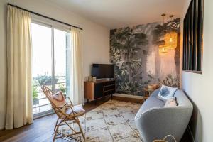 a living room with a couch and a window at Suite in St Raph in Saint-Raphaël
