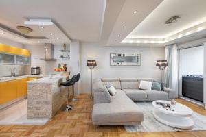 a living room with a couch and a table at Luxury apartman SKY with sea view and whirlpool in Makarska