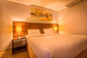 Postel nebo postele na pokoji v ubytování H3 Hotel Paulista