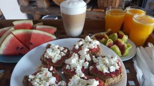 a table with two plates of food and fruit at 7 Olives Apartments in Almyrida