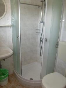 a bathroom with a shower with a toilet and a sink at Villa Radovic in Cavtat