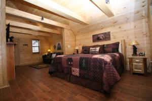 a bedroom with a bed in a wooden cabin at Sweet Memories in Gatlinburg