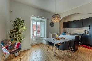a kitchen and dining room with a table and chairs at IMPERIAL Apartment in the center of Biarritz close to the beach in Biarritz