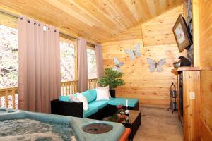 a log cabin with a couch and butterflies on the wall at Sweet Memories in Gatlinburg