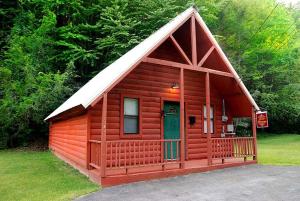 a small red cabin with a gambrel roof at Sweet Memories in Gatlinburg