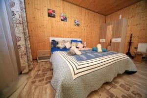 a bedroom with a bed with stuffed animals on it at Sforii Residence in Braşov
