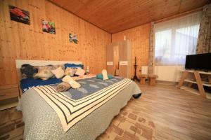 a bedroom with a large bed in a room with wooden walls at Sforii Residence in Braşov