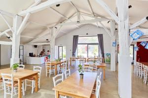 a large room with tables and chairs and a kitchen at Domaine de l'Oiselière in Chauché