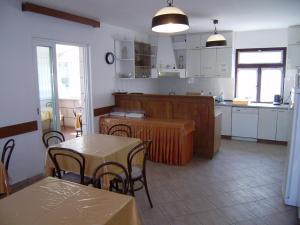 a kitchen and dining room with tables and chairs at Villa Radovic in Cavtat