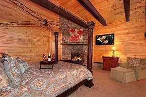a bedroom with a bed and a fireplace at Lover's Loft in Gatlinburg