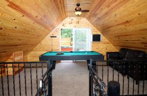 a room with a pool table in a cabin at Lover's Loft in Gatlinburg