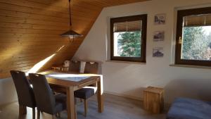 a dining room with a wooden table and chairs at Ferienwohnung Dresden Nickern in Dresden
