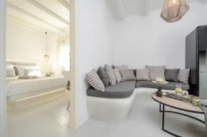 a white living room with a couch and a table at Naxos Secret Paradise Villa in Galini