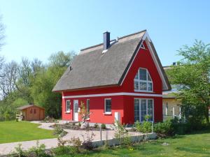 a red house with a gray roof at Ferienhaus Rotmilan in Vieregge
