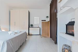 a bedroom with a bed and a fireplace in it at San Martino, 21 in Carovigno