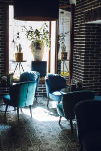 a room with blue chairs and a large window at Penzion U Kubesa - Adults only in Kroměříž