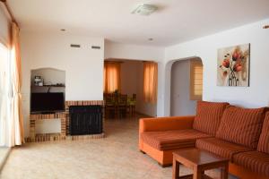 a living room with a couch and a fire place at Villa Coqueta in Sant Josep