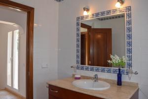 a bathroom with a sink and a mirror at Villa Coqueta in Sant Josep +14 photos
