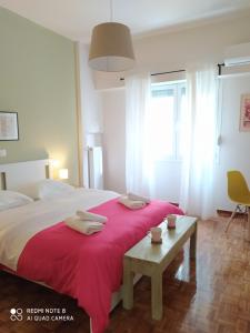 a bedroom with a large bed with a red blanket at Athens Lycabettus Luxurious Loft in Athens