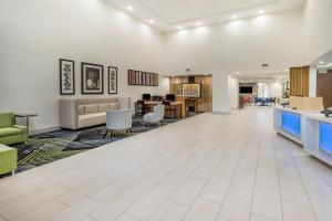 an empty lobby of a hospital with chairs and tables at Holiday Inn Express Hotel & Suites Louisville East by IHG in Louisville
