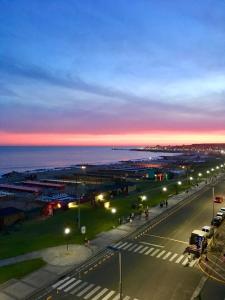 a street with a lot of street lights at night at Depto Frente Al Mar, Edificio Iskofema II in Miramar